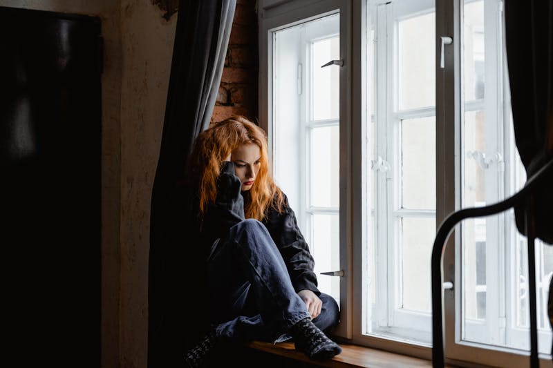 A person caught in a loop of thought, looking away from the camera